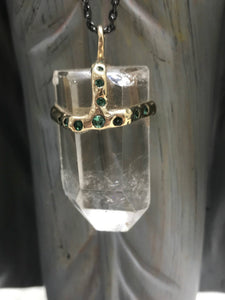 Clear quartz crystal attached to necklace by handmade gold "crown" that also features inset gems