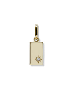 Simple vertical rectangular charm. Charm has a star-burst on bottom right with center diamond. Tag charm is attached to a gold bail