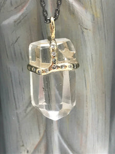 Perfectly Clear quartz crystal attached to necklace by handmade silver "crown" that also features inset diamonds