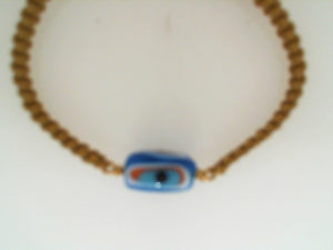 Prehistoric Works gold cord with  24k YG glass evil eye bead