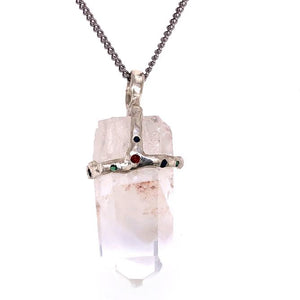 Clear quartz crystal attached to necklace by handmade silver "crown" that also features inset gems
