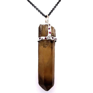 Natural Citrine crystal (amber brown) attached to necklace by handmade silver "crown" that also features inset gems