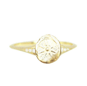 Handmade looking gold ring with simple patterned circle on top