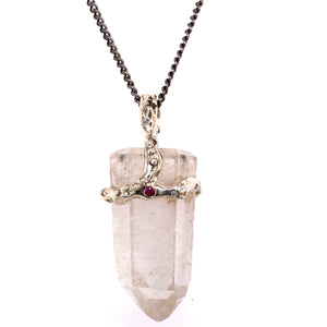 Clear quartz crystal attached to necklace by handmade silver "crown" that also features inset gems (rubies and diamonds)